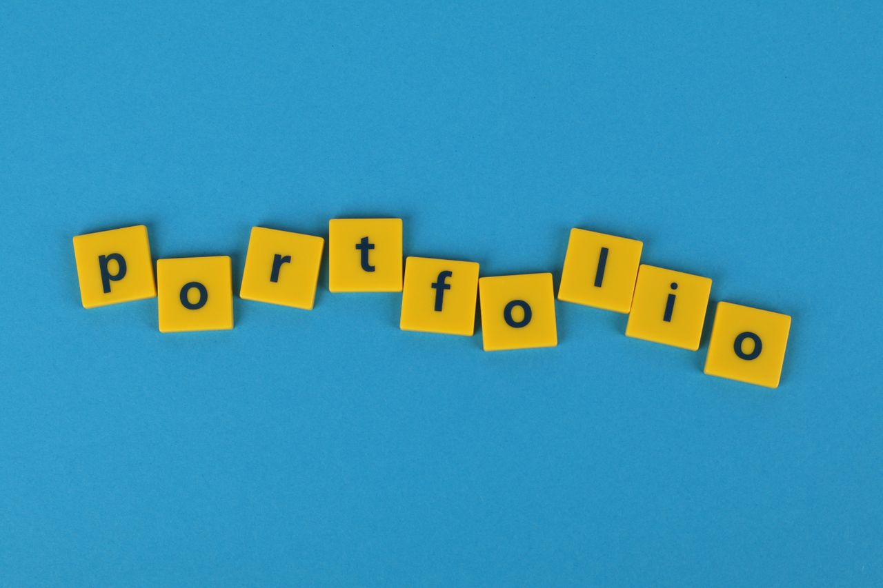 services-02 Yellow Scrabble tiles on a blue background spelling portfolio. Perfect for business themes.
