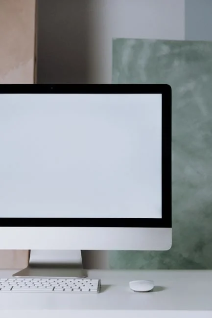A tablet screen featuring images of minimalist decor emphasizing greenery and simple design.